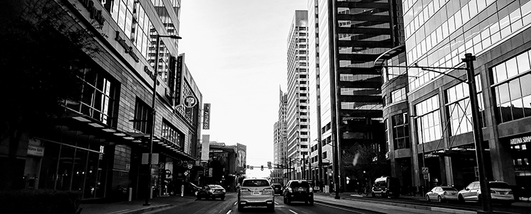 Photo of downtown Phoenix in black and white showing street and buildings 