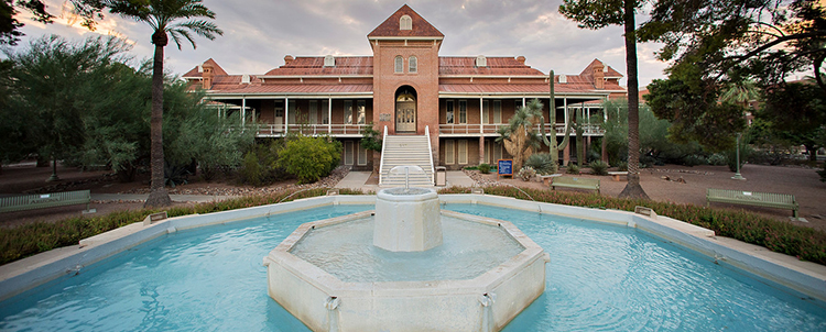Image of Old Main on UArizona campus with fountain in foreground 