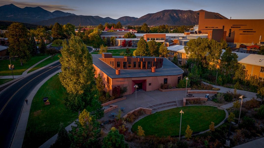 Aerial photo of the NAU campus with mountains in the background. 
