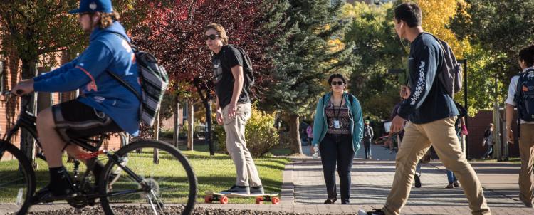 Photo of students on campus with trees in the photo