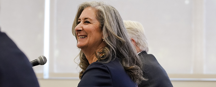 Photo of sideview of Chair Lyndel Manson at a board meeting with Regent DuVal in the background and another individual in the foreground 