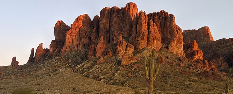 Image of desert, rocky mountains with Saguaro cactus in foreground 