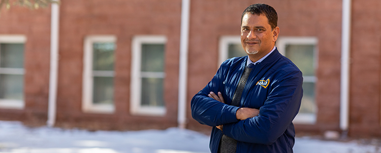 Photo of Dr. Cruz at NAU standing outside