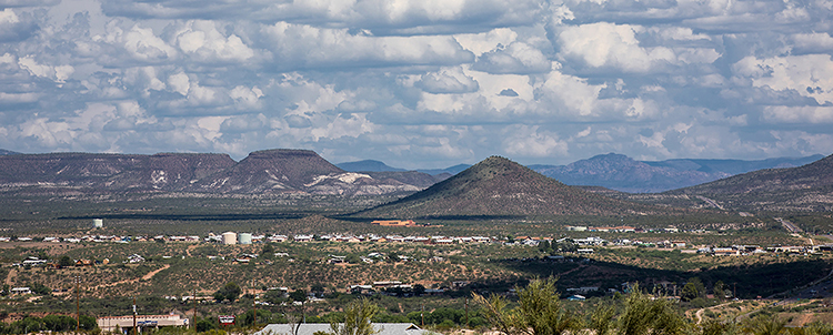 Photo of Phoenix with mountains in the background and cloudy skies 