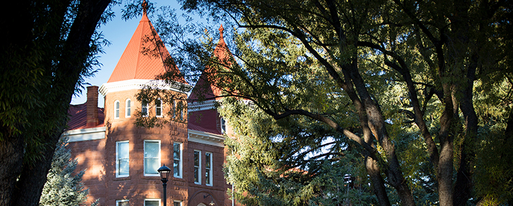 Photo of Old Main on NAU campus with students walking in the foreground