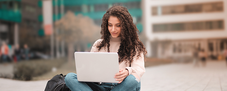 Student typing on laptop 